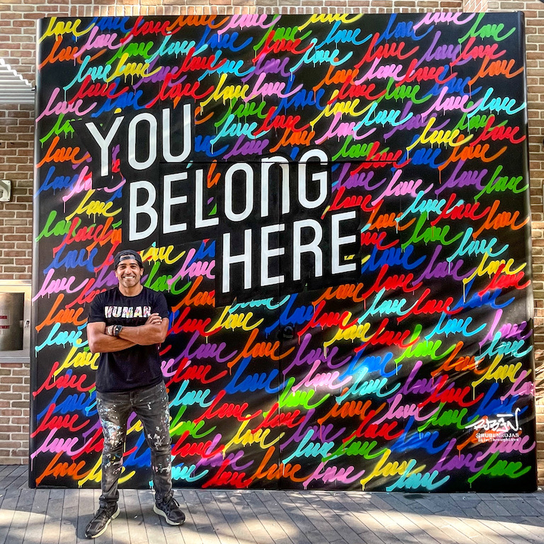 Ruban Rojas and "You Belong Here" mural.