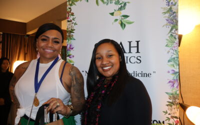 Grammy nominee Queen Sheba stops by the Siyah Organics display at the DPA Music Lounge.