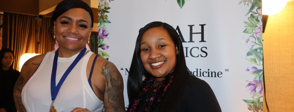 Grammy nominee Queen Sheba stops by the Siyah Organics display at the DPA Music Lounge.